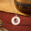 Koi Fish Peace Buckle Necklace – jade disc with silver koi overlay, crystals, on burgundy velvet with props