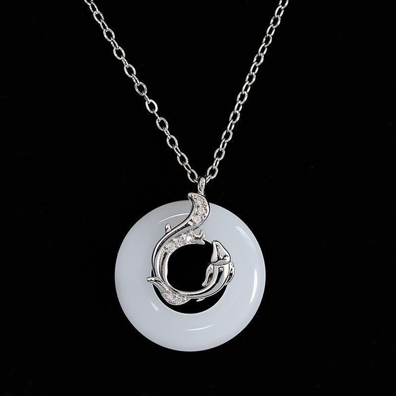 Koi Fish Peace Buckle Necklace – jade ping an kou disc with silver fish overlay, crystals, on pure black background