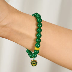 Green Agate Lotus Charm Beaded Bracelet - Side wrist view showing enamel lotus focal and turquoise cord, natural agate