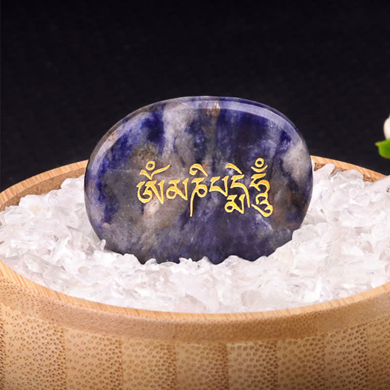 Om Mani Padme Hum Palm Stone – Blue sodalite with gold mantra in crystal bed