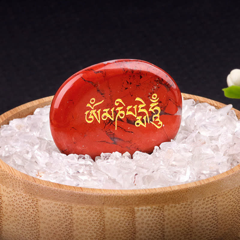 Om Mani Padme Hum Palm Stone – Red jasper with gold Tibetan text in quartz chip bowl