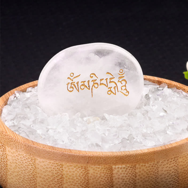 Om Mani Padme Hum Palm Stone – Milky white crystal with gold Tibetan text in wooden bowl