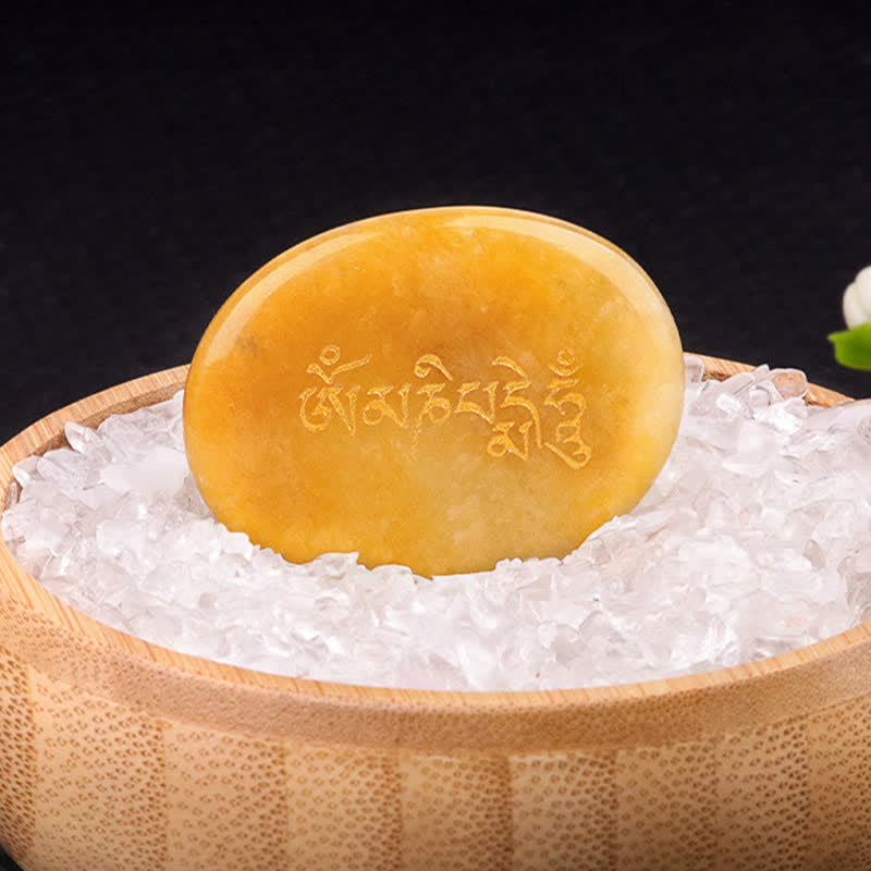 Om Mani Padme Hum Palm Stone – Translucent amber stone disc with gold mantra, warm glow
