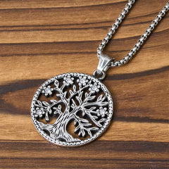 Tree of Life Titanium Steel Necklace – Close-up of silver Tree of Life pendant detail on striped wood