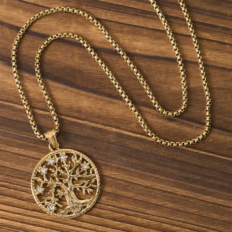 Tree of Life Titanium Steel Necklace – Gold necklace with chain arranged on dark wood, overhead view