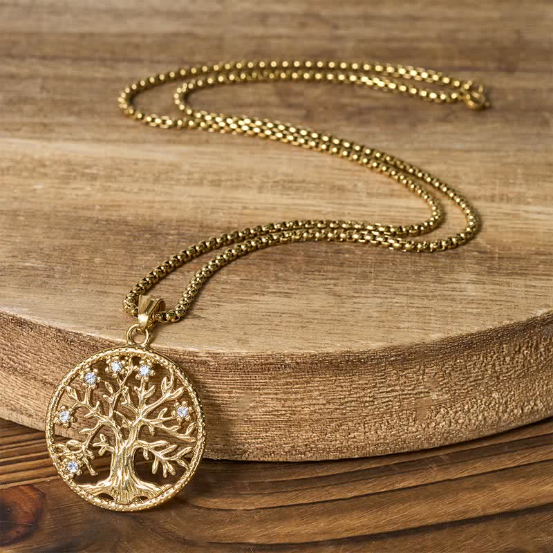 Tree of Life Titanium Steel Necklace – Full gold necklace on wood slab showing box chain and pendant