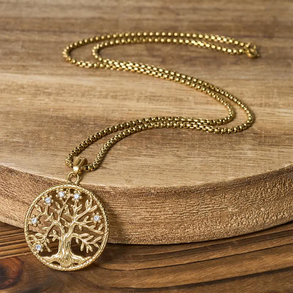 Tree of Life Titanium Steel Necklace – Full gold necklace on wood slab showing box chain and pendant
