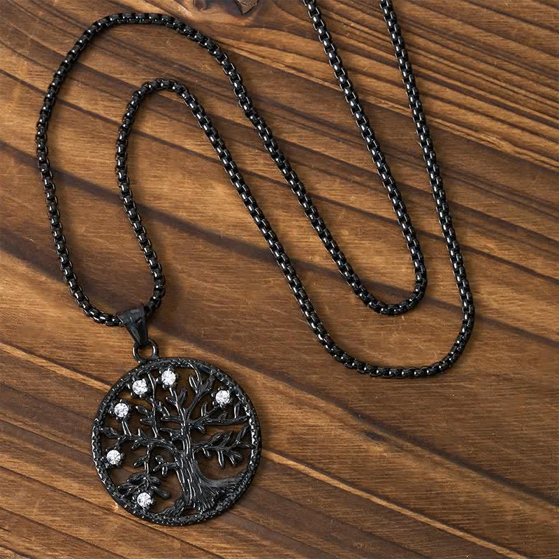 Tree of Life Titanium Steel Necklace – Black necklace with chain arranged on dark wood, overhead view