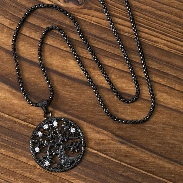 Tree of Life Titanium Steel Necklace – Black necklace with chain arranged on dark wood, overhead view
