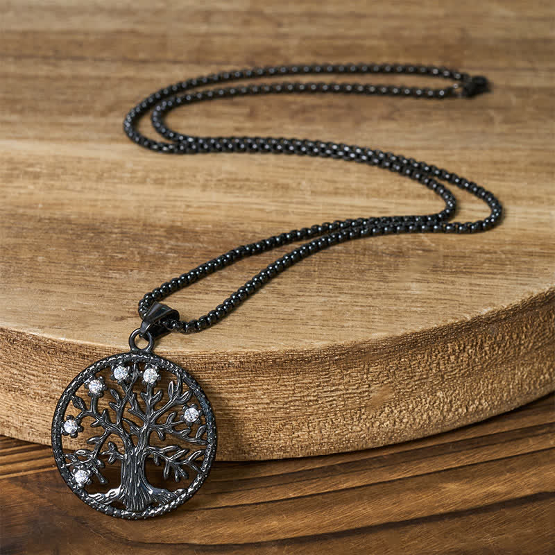 Tree of Life Titanium Steel Necklace – Full black necklace on wood slab showing chain length and pendant