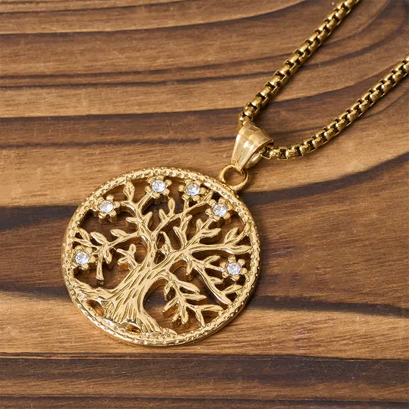 Tree of Life Titanium Steel Necklace – Close-up gold Tree of Life with crystal flowers on striped wood