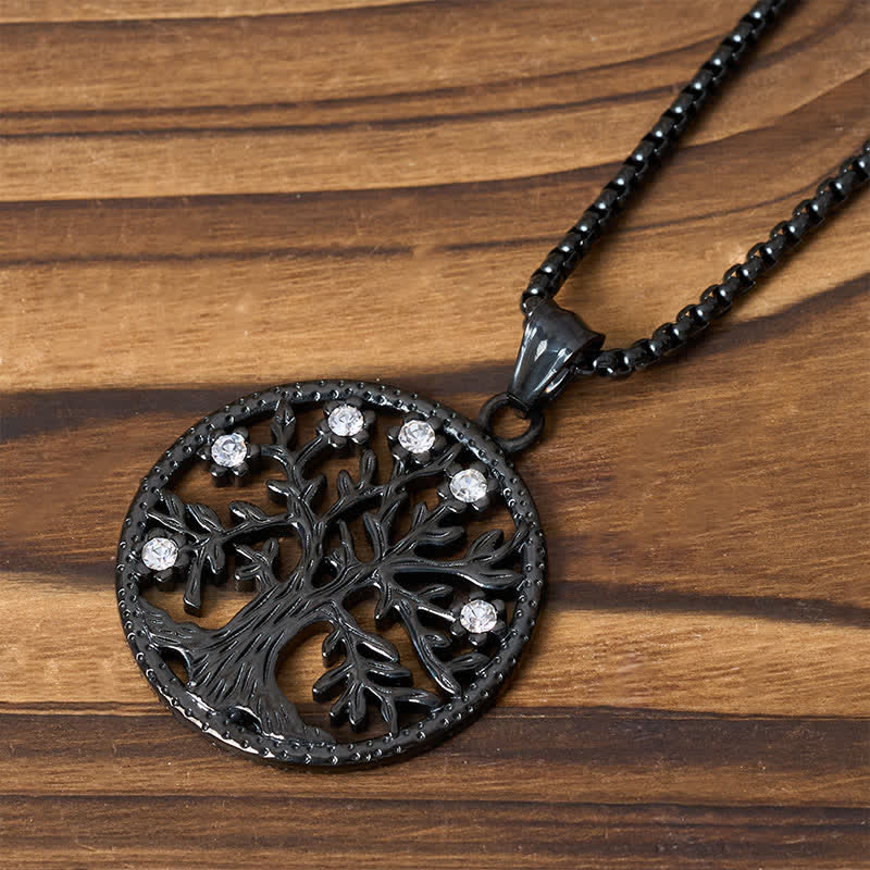 Tree of Life Titanium Steel Necklace – Close-up black Tree of Life with crystal accents on striped wood