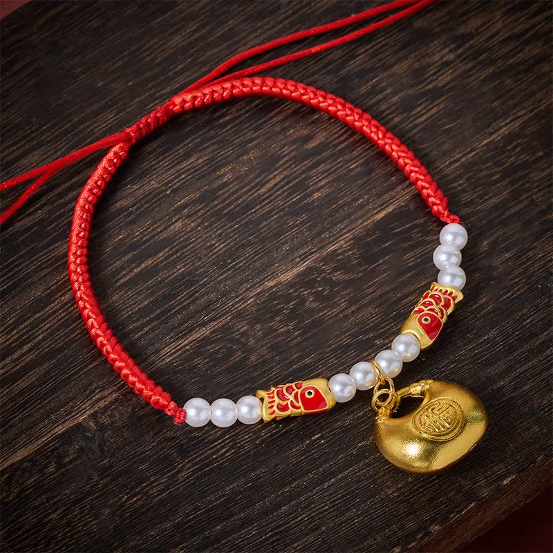 Red String Koi Fish Pet Collar – overhead on dark wood, red cord with gold lock pendant, koi beads, white pearls