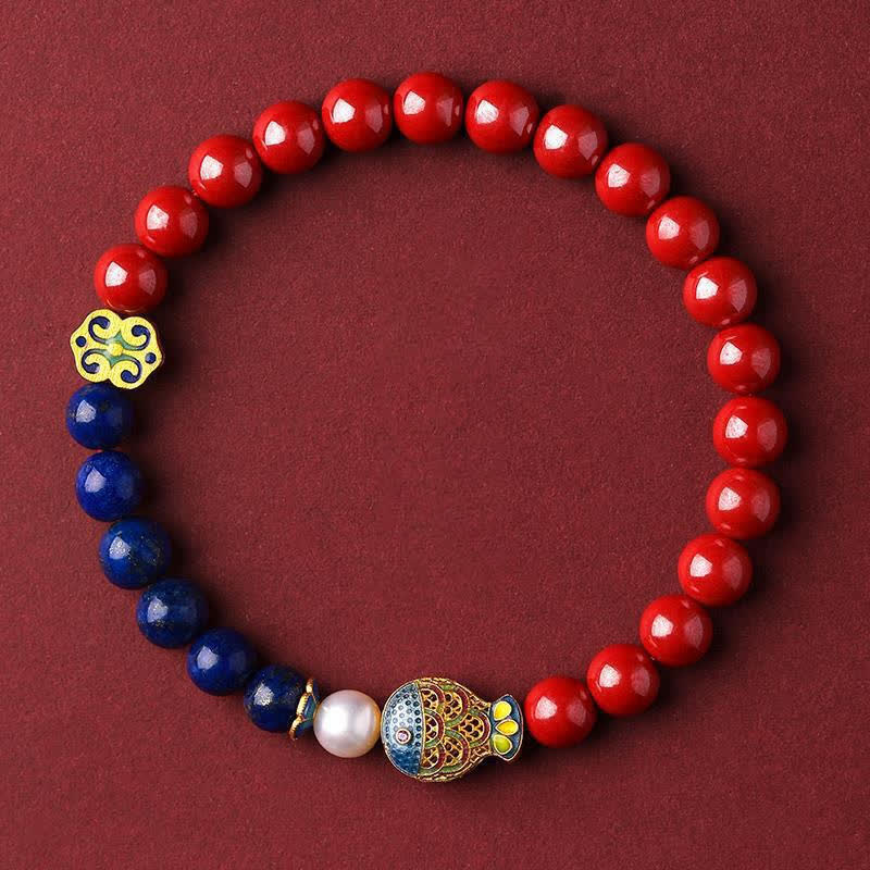 Cinnabar Lapis Lazuli Koi Fish Bracelet – flat lay on burgundy fabric, top-down macro product view