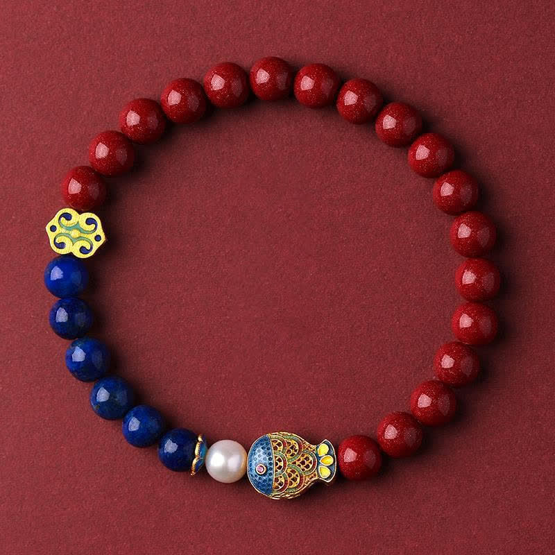 Cinnabar Lapis Lazuli Koi Fish Bracelet – red and blue bead bracelet with koi charm on burgundy fabric