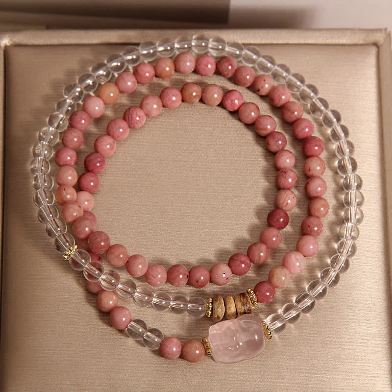 Rhodonite Clear Quartz Rose Quartz Pixiu Triple Wrap Bracelet – overhead triple wrap on gold box with Pixiu charm