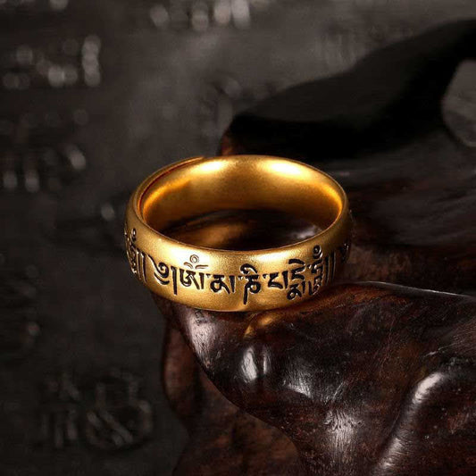 Om Mani Padme Hum Ring – Gold band with Tibetan engraving on carved wood stand, mantra ring