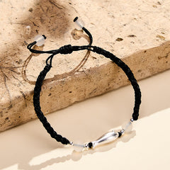 999 Sterling Silver Koi Fish Bracelet – bracelet on angled travertine stone slab, three-quarter view