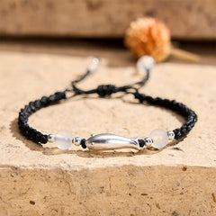 999 Sterling Silver Koi Fish Bracelet – silver koi charm with white agate on black braided rope, stone surface