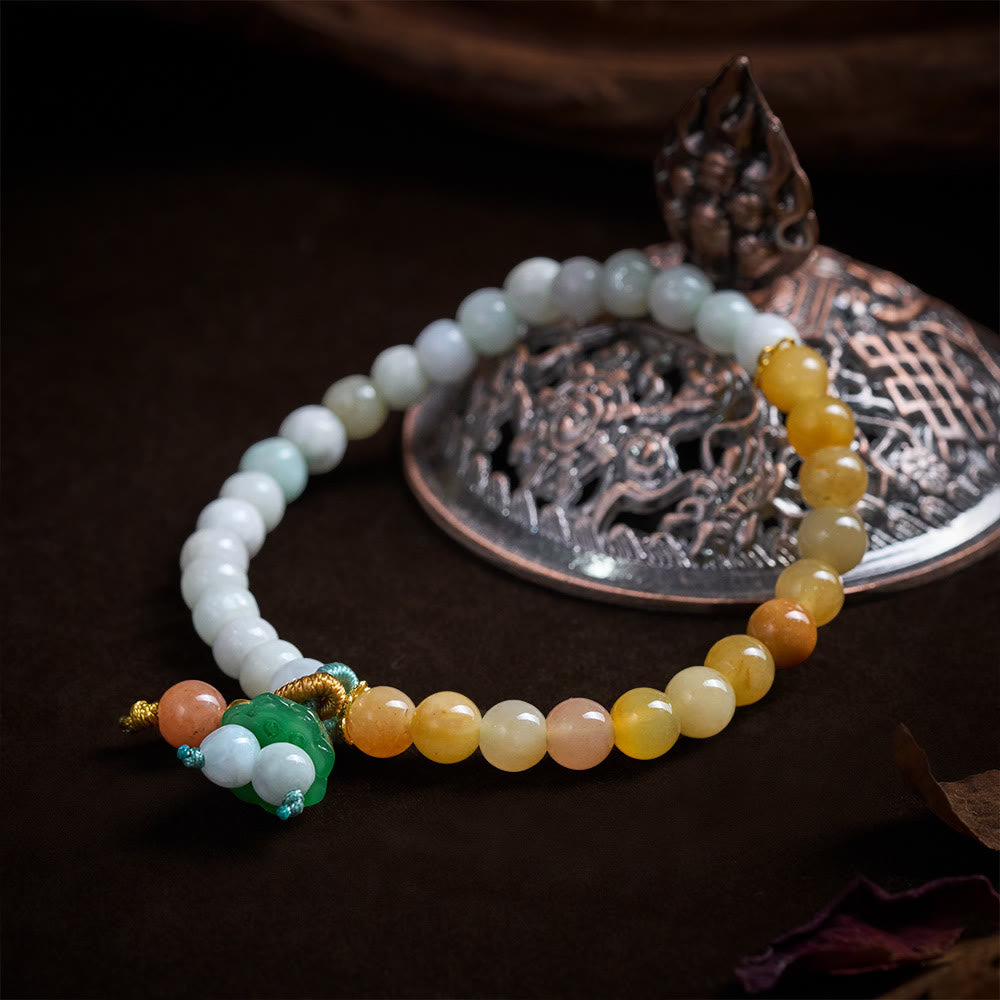 Multi-color jadeite beaded bracelet with carved green focal bead on bronze incense burner, jade bracelet