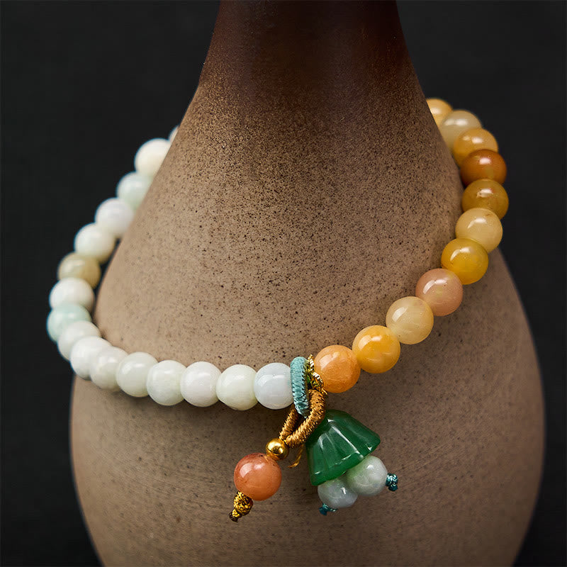 Gradient jade beaded bracelet with carved green lotus pod charm, white to amber tones, jade bracelet