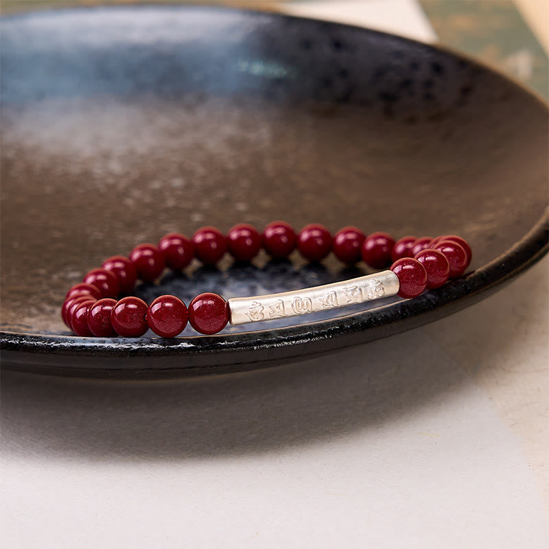 Sterling Silver Om Mani Padme Hum Bracelet – Silver focal bead on dark dish, cinnabar sterling silver jewelry