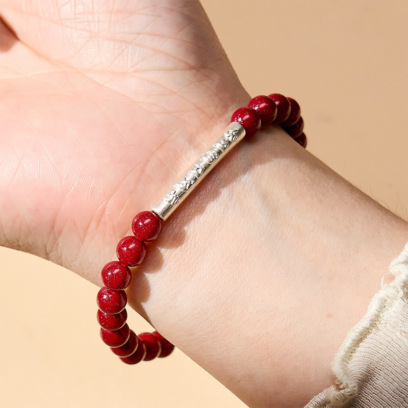 Sterling Silver Om Mani Padme Hum Bracelet – Silver cylinder worn on wrist, red cinnabar wristlet