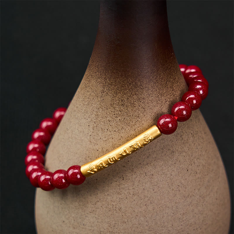 Cinnabar Om Mani Padme Hum Bracelet – Gold engraved tube on ceramic vase, red stone stretch bracelet