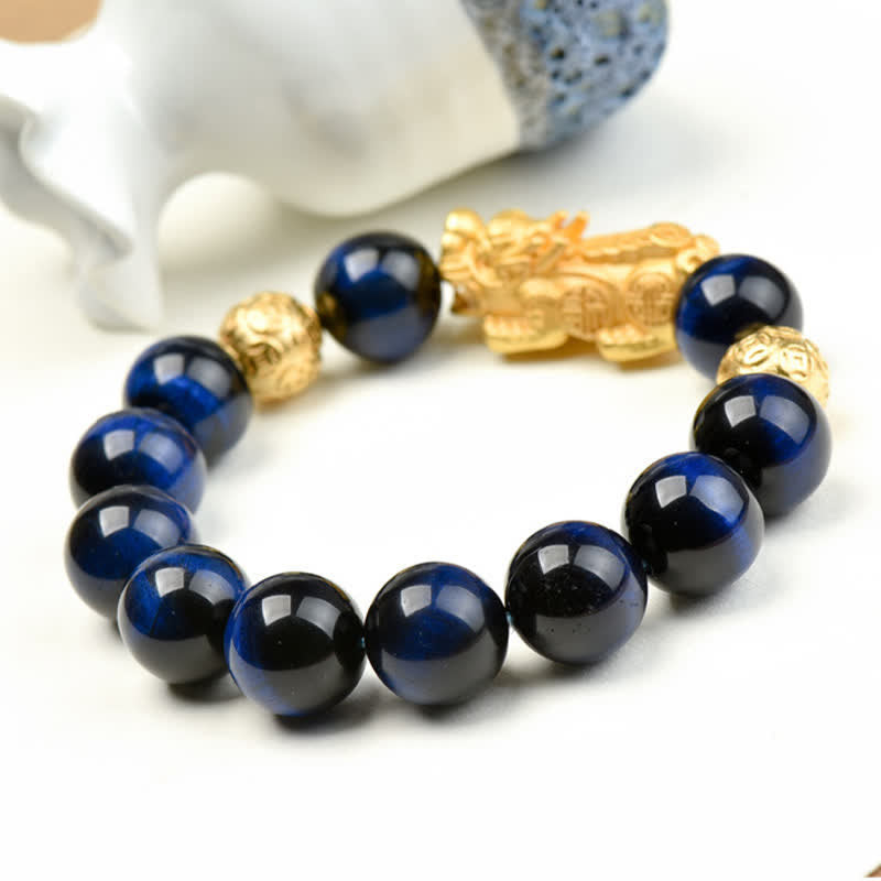 Natural Tiger Eye Pixiu Fu Om Mani Padme Hum Bracelet – blue tiger eye beads with golden Pixiu near white ceramic decor
