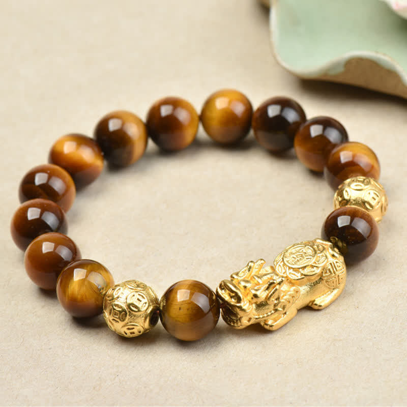 Natural Tiger Eye Pixiu Fu Om Mani Padme Hum Bracelet – golden Pixiu with brown tiger eye beads on light cream surface