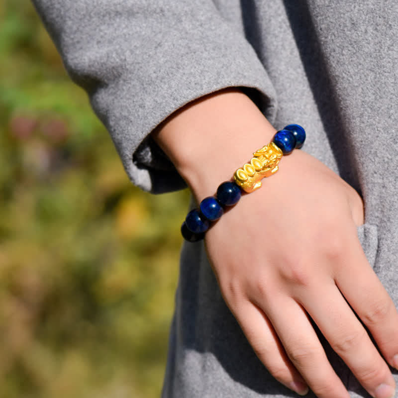 Natural Tiger Eye Pixiu Fu Om Mani Padme Hum Bracelet – blue tiger eye on wrist outdoors with grey sleeve, feng shui luck