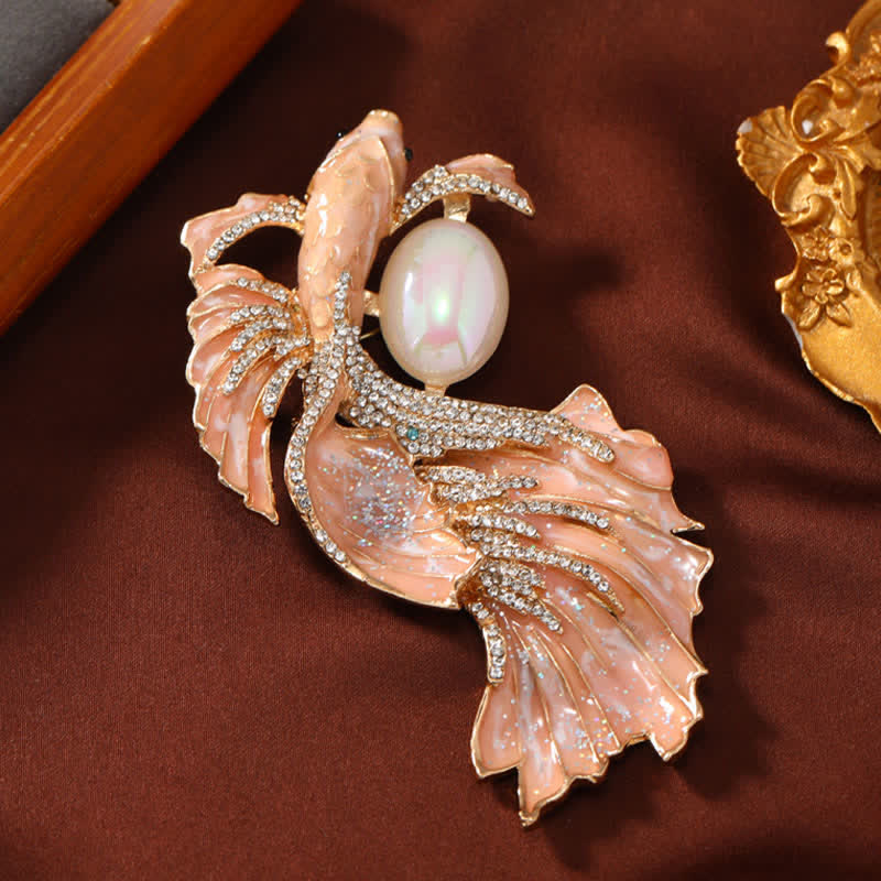 Glazed Koi Fish Pearl Brooch – salmon-pink glazed koi with crystal pave, photographed on rustic fabric
