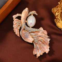 Glazed Koi Fish Pearl Brooch – salmon-pink glazed koi with crystal pave, photographed on rustic fabric