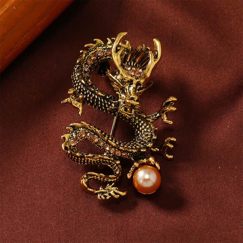 Domineering Dragon Pearl Strength Alloy Brooch – gold dragon with amber stones and peach pearl on burgundy velvet, power