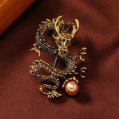 Domineering Dragon Pearl Strength Alloy Brooch – gold dragon with amber stones and peach pearl on burgundy velvet, power