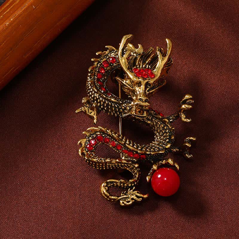 Domineering Dragon Pearl Strength Alloy Brooch – gold dragon with red crystals and fiery pearl on wine fabric, strength