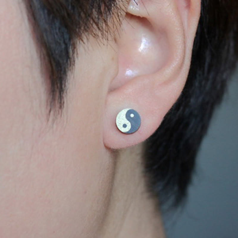 Ebony Wood Yin Yang Stud Earrings - Silver and black yin yang stud earring worn on ear, minimalist balance jewelry