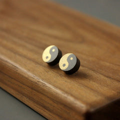 Ebony Wood Yin Yang Stud Earrings - Angled view of gold and silver yin yang wood inlay studs, zen jewelry