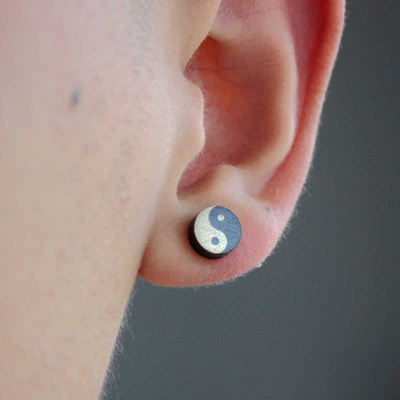 Ebony Wood Yin Yang Stud Earrings - Worn on earlobe showing wood grain in black and cream, natural yin yang jewelry