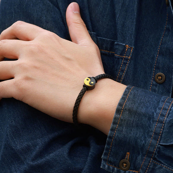 Yin Yang Bagua Leather Bracelet - Wrist close-up on denim showing gold yin yang symbol, balance jewelry