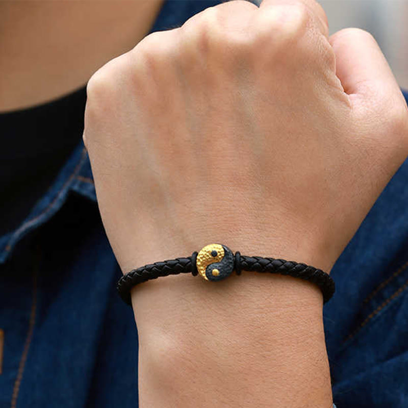 Yin Yang Bagua Leather Bracelet - On wrist with denim showing braided leather and gold charm, mens yoga bracelet