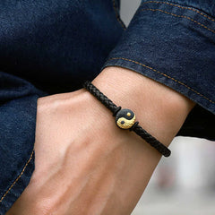 Yin Yang Bagua Leather Bracelet - Worn on wrist with dark denim showing gold yin yang charm, leather bracelet men