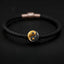 Yin Yang Bagua Leather Bracelet - Black braided leather with gold yin yang charm on dark background, yin yang jewelry