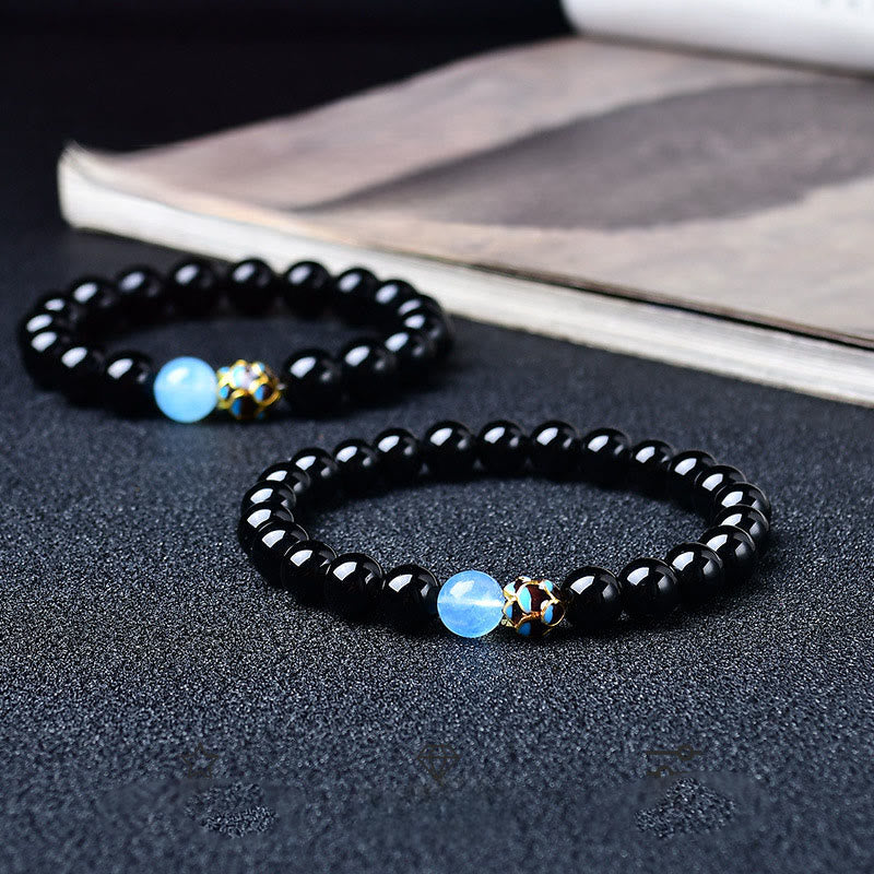 Black Obsidian Lotus Purification Bracelet - dual bracelets with blue opalite and cloisonne bead on dark surface, healing jewelry