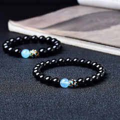 Black Obsidian Lotus Purification Bracelet - dual bracelets with blue opalite and cloisonne bead on dark surface, healing jewelry