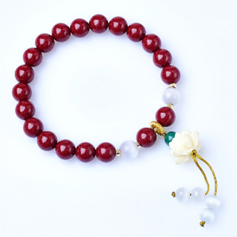 Cinnabar Cat's Eye Lotus Blessing Bracelet - white background overhead shot, red beads with white accent stones