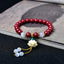 Cinnabar Cat's Eye Lotus Blessing Bracelet - red beads with carved lotus charm on ink-wash book, spiritual jewelry