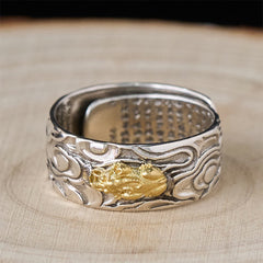 PiXiu Heart Sutra Copper Ring – Top view on light wood, gold Pi Xiu centerpiece, mantra text inside band, feng shui