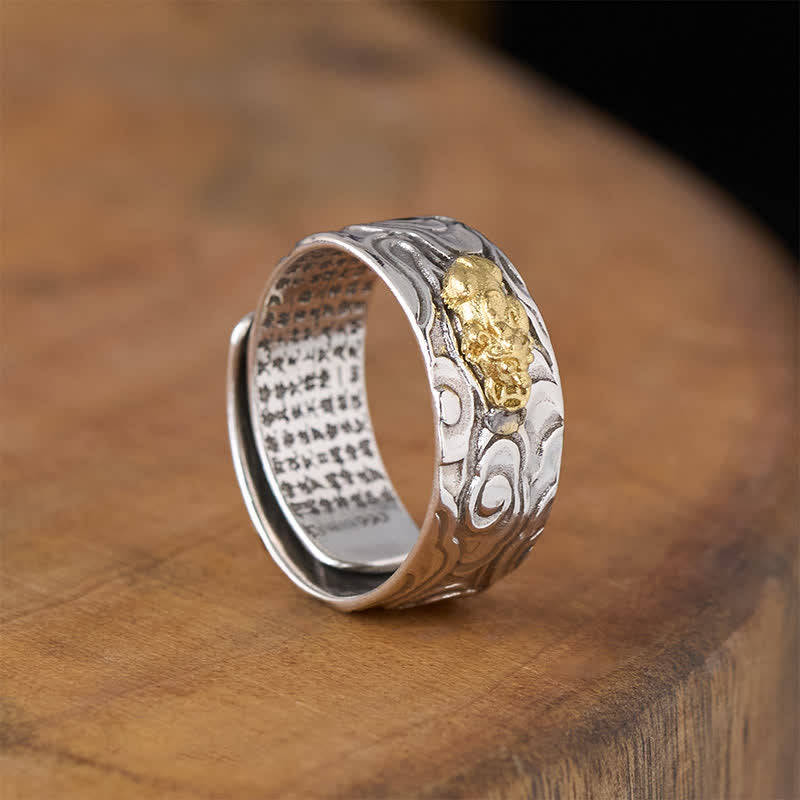 PiXiu Heart Sutra Copper Ring – Tilted side on brown wood, gold Pi Xiu and cloud motif, adjustable copper band