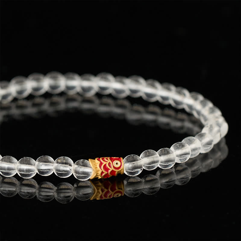 Clear Quartz Koi Fish Bracelet - clear beaded bracelet by dark ceramic vessel, koi accent